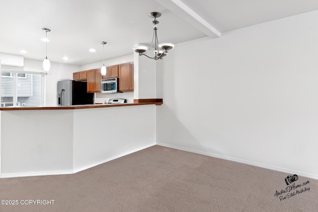 6507 Kara Sue Loop # 83, Anchorage, AK 99504 - kitchen with carpet, appliances with stainless steel finishes, recessed lighting, pendant lighting, and a chandelier