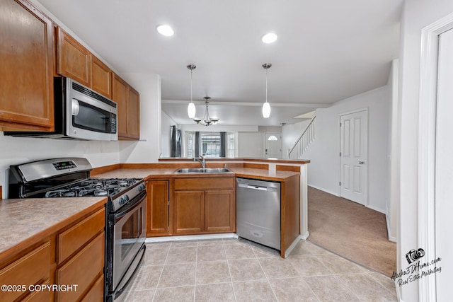 6507 Kara Sue Loop # 83, Anchorage, AK 99504 - kitchen with stainless steel appliances, a peninsula, brown cabinets, hanging light fixtures, and light tile patterned floors