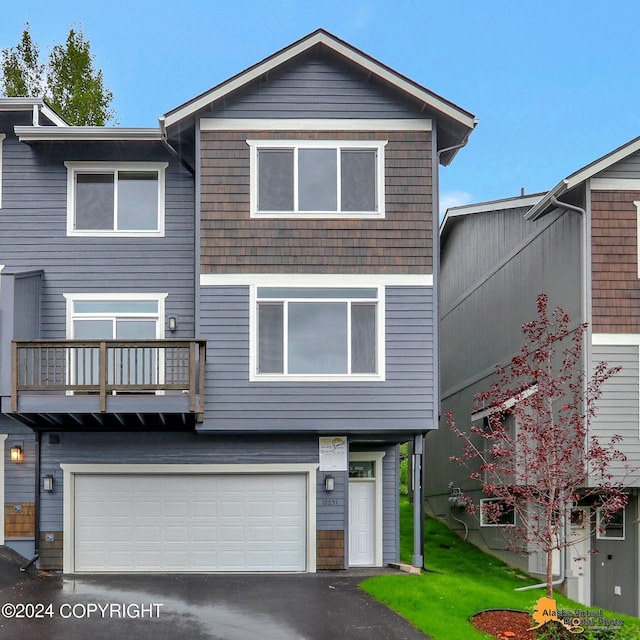 12229 Vista Ridge Loop, Eagle River, AK 99577 - view of front of home with an attached garage, a balcony, and asphalt driveway