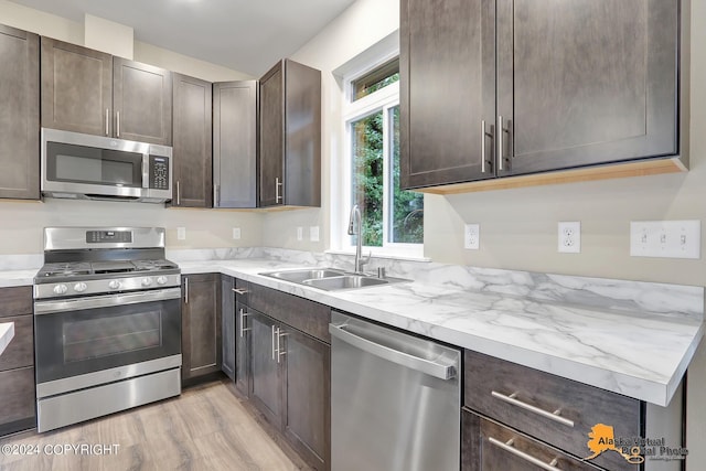 12229 Vista Ridge Loop, Eagle River, AK 99577 - kitchen with stainless steel appliances, dark brown cabinets, and light wood-type flooring