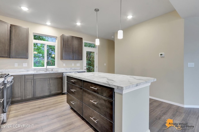 12229 Vista Ridge Loop, Eagle River, AK 99577 - kitchen featuring light wood finished floors, appliances with stainless steel finishes, dark brown cabinets, a center island, and hanging light fixtures