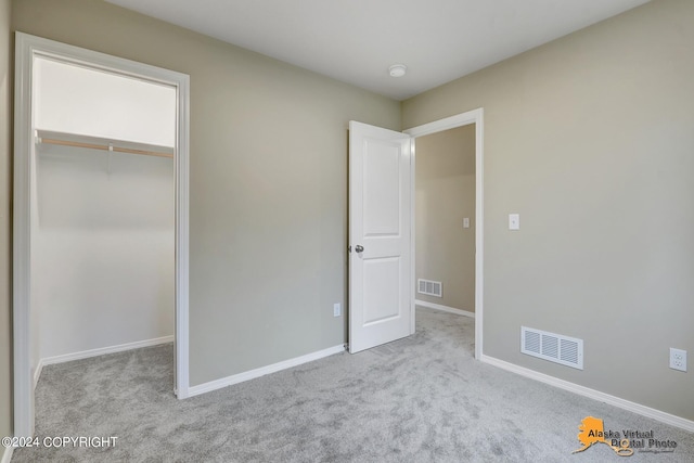 12229 Vista Ridge Loop, Eagle River, AK 99577 - unfurnished bedroom featuring carpet flooring and a spacious closet