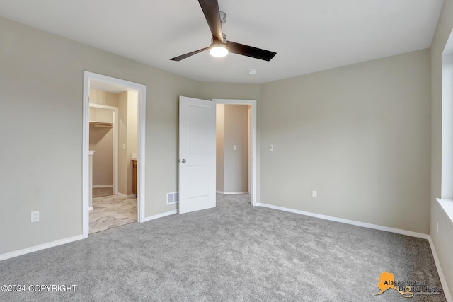 12229 Vista Ridge Loop, Eagle River, AK 99577 - unfurnished bedroom with carpet floors, ceiling fan, and connected bathroom