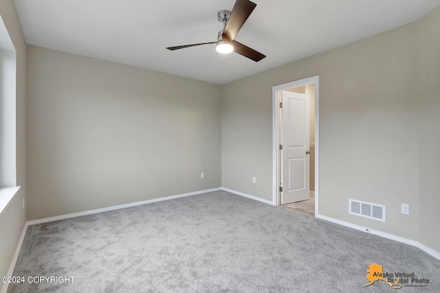 12229 Vista Ridge Loop, Eagle River, AK 99577 - carpeted spare room with a ceiling fan and baseboards