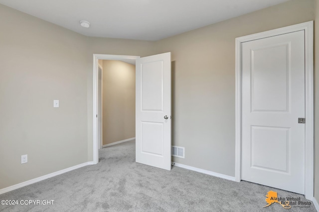 12229 Vista Ridge Loop, Eagle River, AK 99577 - unfurnished bedroom with carpet and baseboards