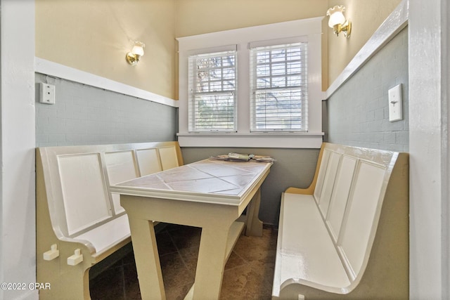 dining area with dark tile flooring