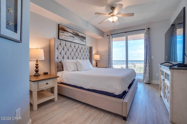 bedroom with access to outside, light wood-type flooring, a ceiling fan, and baseboards