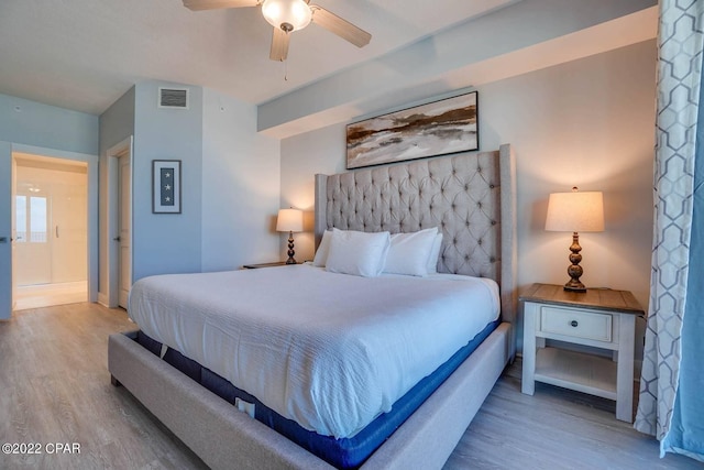 bedroom with a ceiling fan, visible vents, and wood finished floors