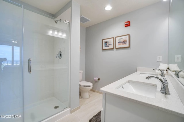 full bathroom with a stall shower, a sink, toilet, and double vanity