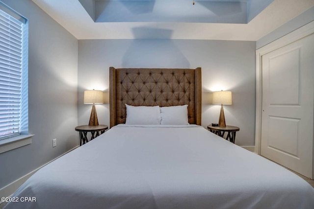 bedroom with a tray ceiling