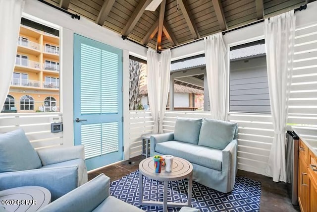 sunroom with lofted ceiling with beams and wooden ceiling