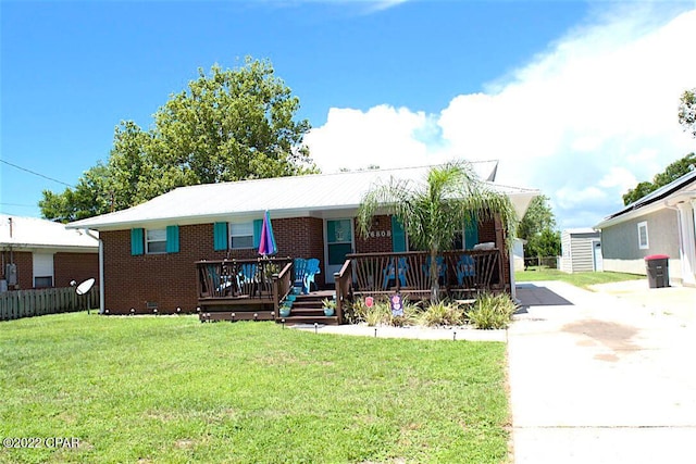 view of front facade with a deck and a front yard