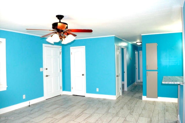 spare room featuring crown molding and ceiling fan