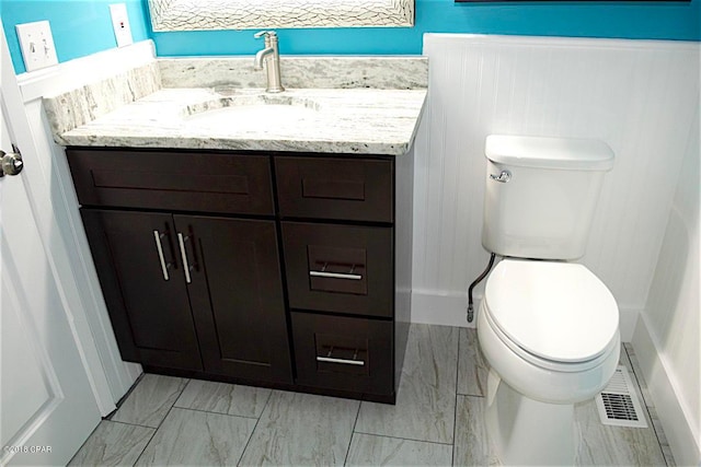 bathroom featuring tile floors, toilet, and vanity