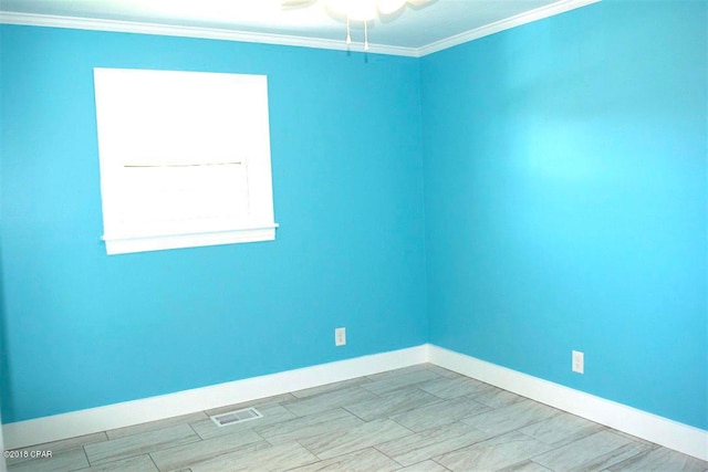 empty room featuring ceiling fan and crown molding