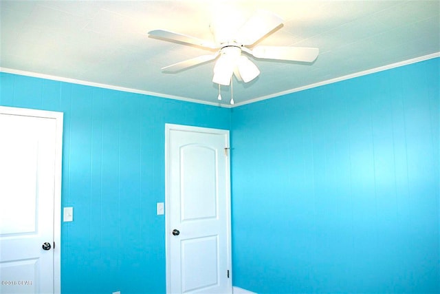 interior space with crown molding and ceiling fan