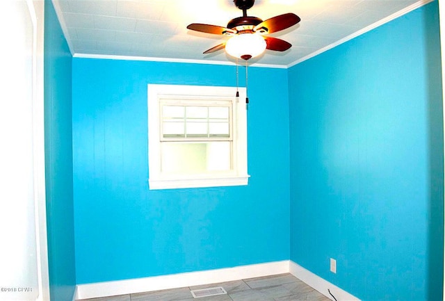 empty room featuring ceiling fan and ornamental molding