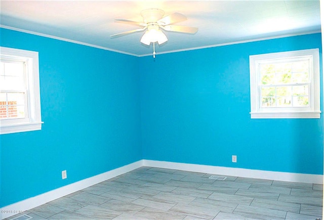 tiled empty room with ornamental molding and ceiling fan