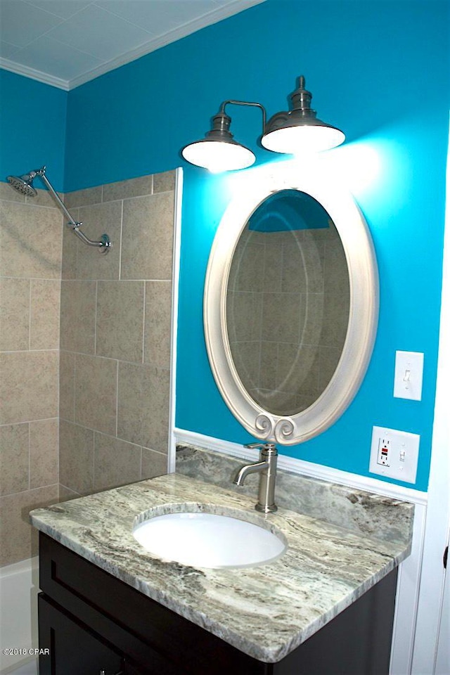 bathroom with crown molding and vanity