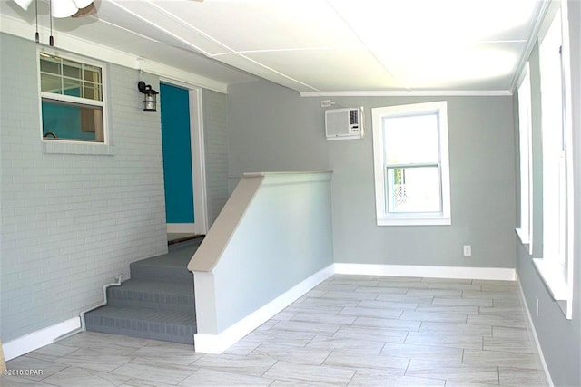 stairs featuring light tile floors, crown molding, and a wall mounted AC