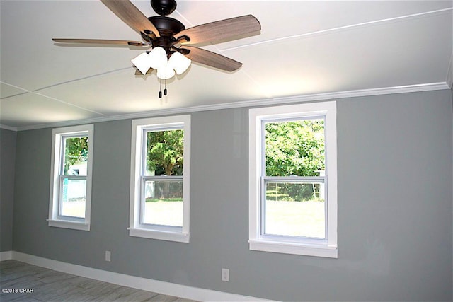 unfurnished room with ceiling fan, hardwood / wood-style flooring, and ornamental molding