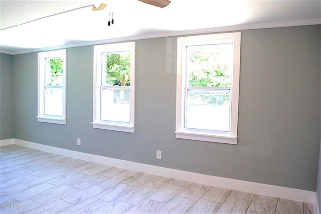 empty room featuring plenty of natural light, ornamental molding, and ceiling fan