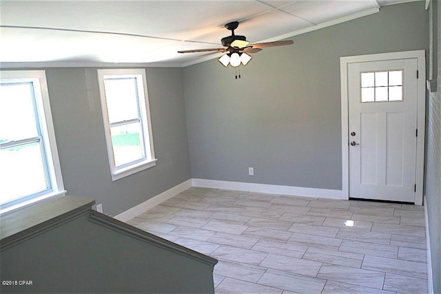 tiled foyer entrance with crown molding, a healthy amount of sunlight, and ceiling fan