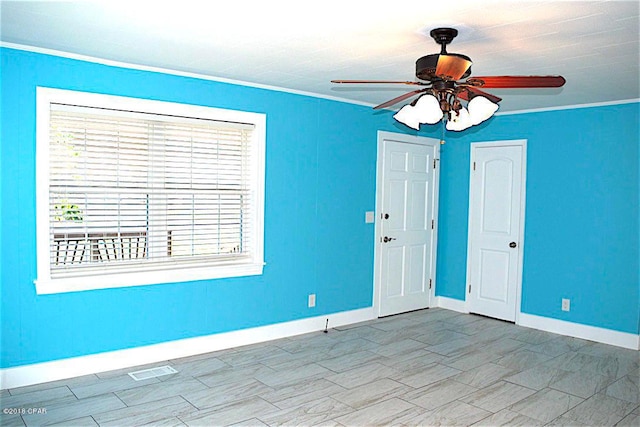 empty room with crown molding and ceiling fan