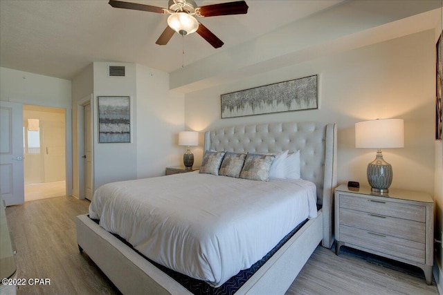 bedroom with light hardwood / wood-style floors and ceiling fan