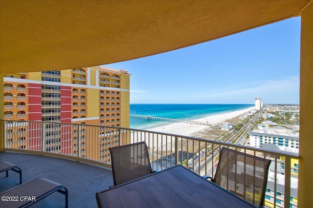 balcony featuring a water view and a view of the beach