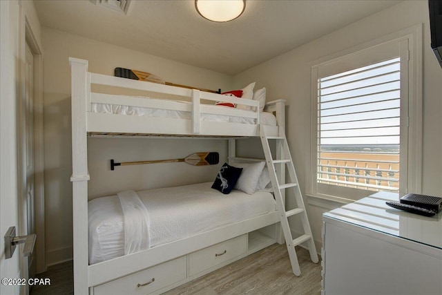 bedroom featuring light hardwood / wood-style floors and radiator