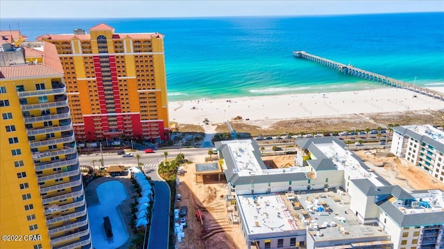 drone / aerial view featuring a beach view and a water view