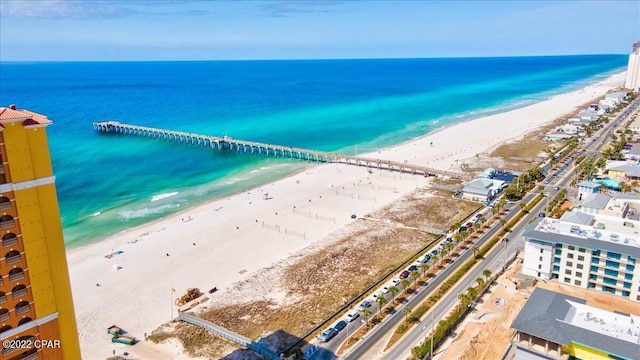 bird's eye view featuring a water view and a beach view