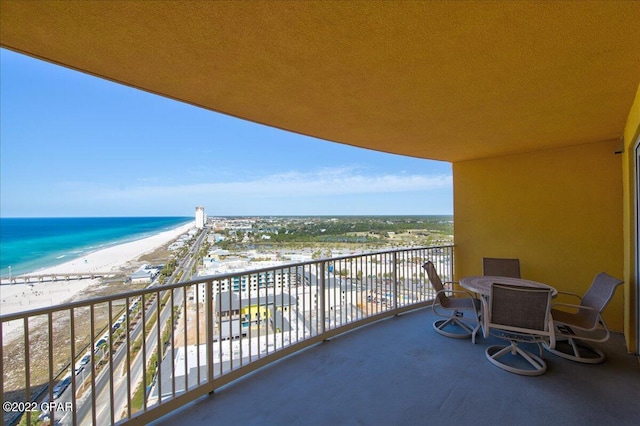 balcony featuring a water view and a beach view