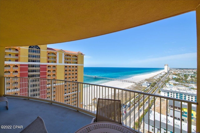 balcony featuring a beach view and a water view