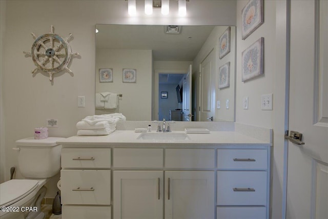 bathroom with toilet and vanity