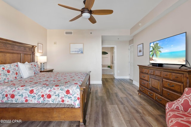 bedroom with ensuite bathroom, ceiling fan, and dark wood-type flooring