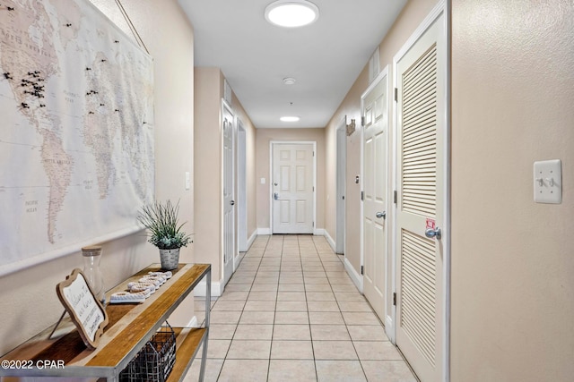 hall featuring light tile floors