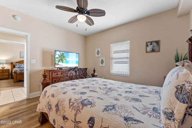 bedroom with ceiling fan and light hardwood / wood-style flooring