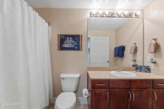 bathroom with tile floors, vanity with extensive cabinet space, and toilet