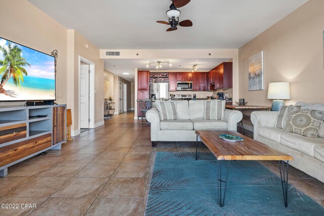 living room featuring rail lighting, ceiling fan, and tile flooring