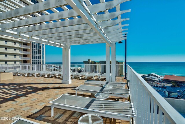 view of patio / terrace with a balcony, a water view, and a pergola