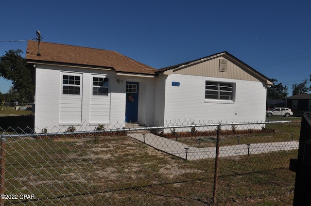 ranch-style home featuring a front yard