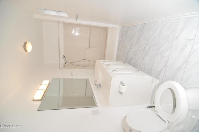 bathroom with tile walls and toilet