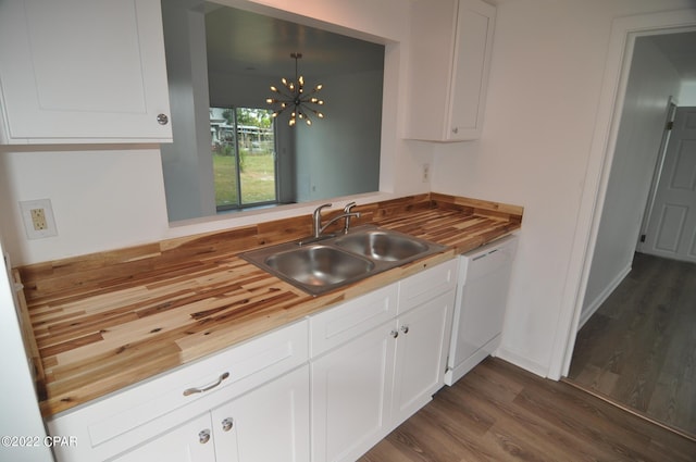 kitchen with sink, dishwasher, dark wood-type flooring, a notable chandelier, and white cabinetry