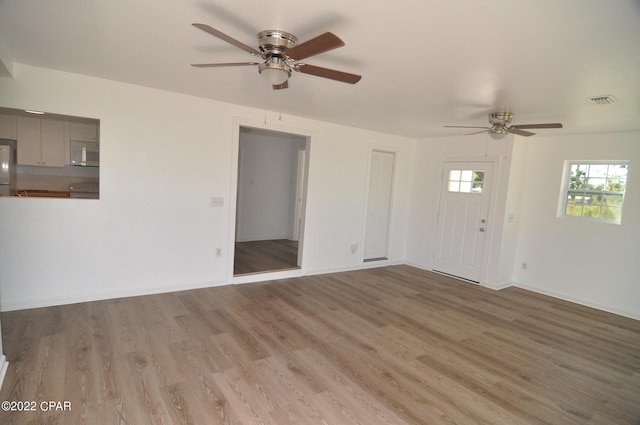 spare room with ceiling fan and hardwood / wood-style flooring