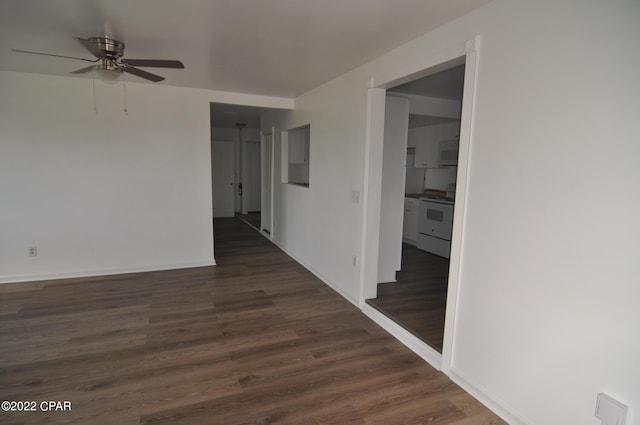 empty room featuring ceiling fan and dark wood-type flooring