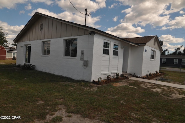 view of home's exterior with a yard