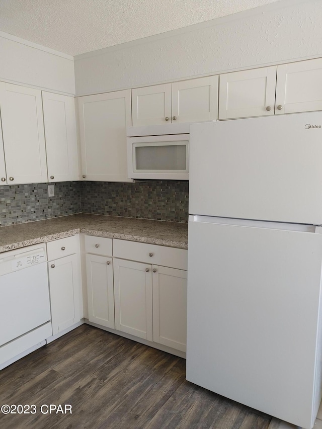 kitchen featuring tasteful backsplash, white appliances, and dark hardwood / wood-style flooring