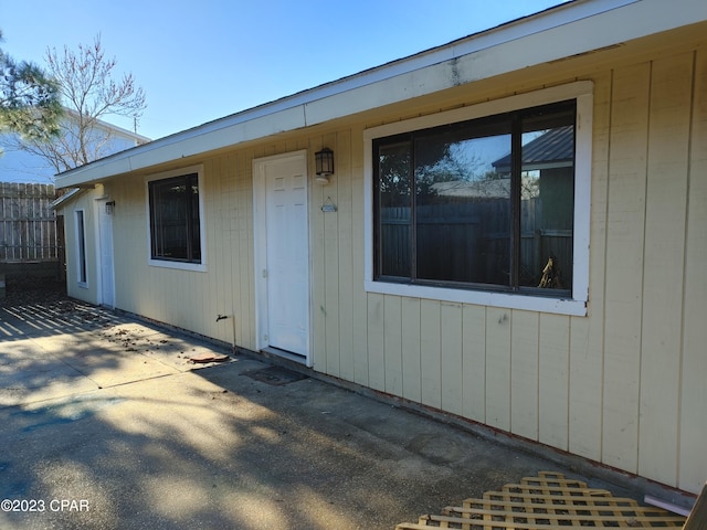 view of exterior entry with a patio area